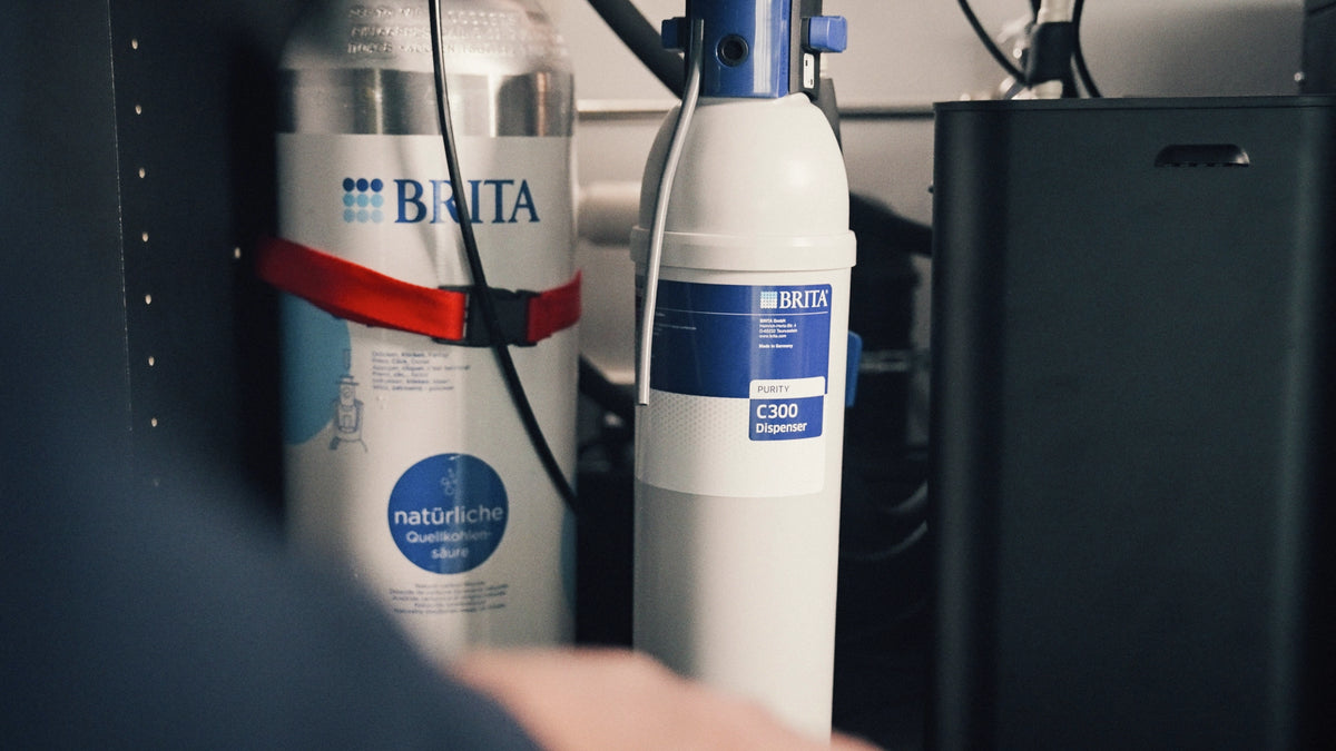 Base cabinet of a water dispenser with a co2 cylinder and a filter.