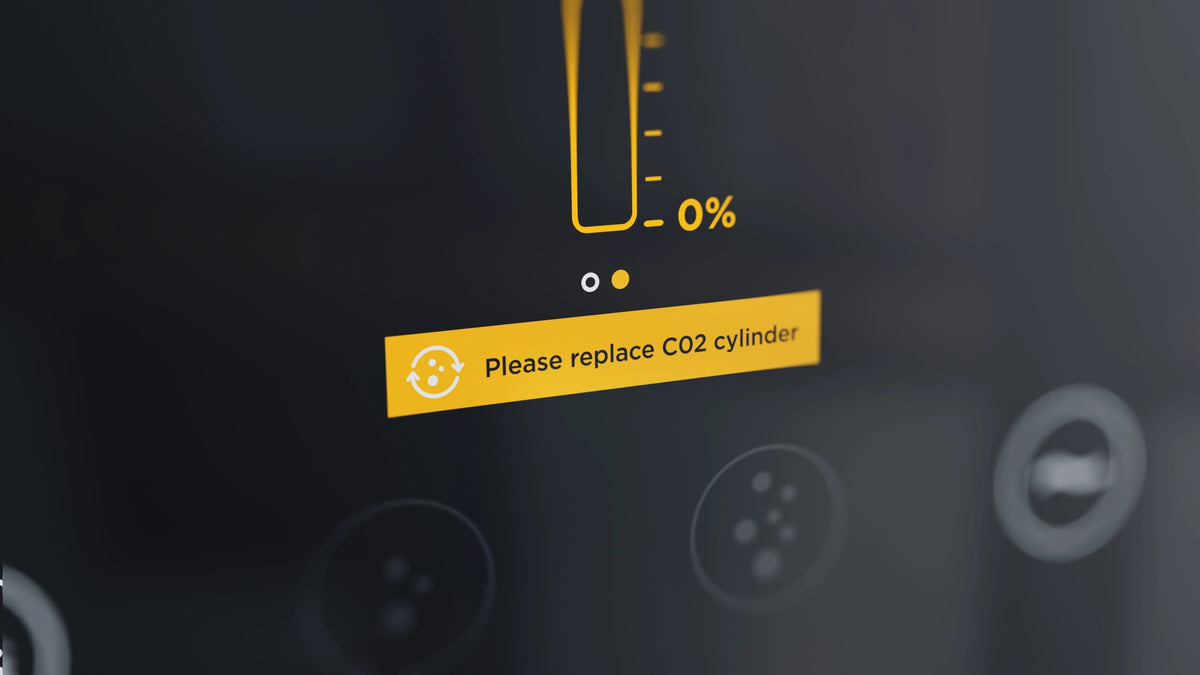 Warning label on a water dispenser indicating a low CO₂ cylinder level.